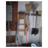 Corner lot of mops, step ladder, rakes & more