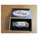 Commemorative folding knife in a wo...