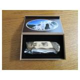 Commemorative folding knife in a wo...