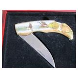 Commemorative folding knife in a wo...