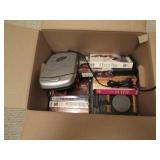 Box of VHS tapes and a VHS tape rew...