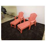 pair of red Composite Adirondack chairs each with footrest extensions.