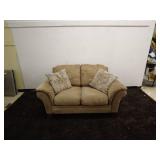 Tan Loveseat Sofa with Patterned Accent Pillows