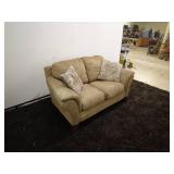 Tan Loveseat Sofa with Patterned Accent Pillows