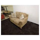 Tan Loveseat Sofa with Patterned Accent Pillows