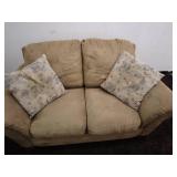 Tan Loveseat Sofa with Patterned Accent Pillows