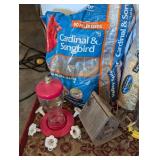 Partial Bags of Birdseed and Feeders