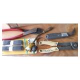 Box of pliers, snips, wrenches, wire stripper, velcro, torch