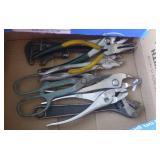 Box of pliers, snips, wrenches, wire stripper, velcro, torch