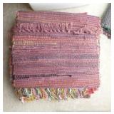 group of woven rag rugs and 3 waste baskets