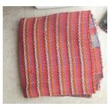 group of woven rag rugs and 3 waste baskets