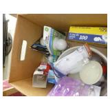 Box full of dusters, bath scrubbies, light bulbs