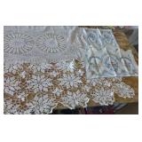 This lot has 4 large dresser scarves, some doilies and arm covers