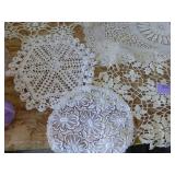 This lot has 4 large dresser scarves, some doilies and arm covers