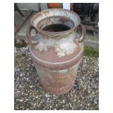 Patio umbrella with a milk can to hold it