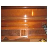 Everett piano with bench and sheet music