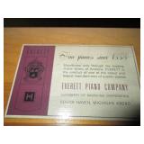 Everett piano with bench and sheet music