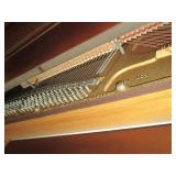 Everett piano with bench and sheet music