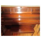 Everett piano with bench and sheet music