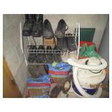 Corner contents behind the door of utility room including mens shoes and shop vac