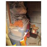 Corner contents of utility room. Vacuum cleaner, totes of old newspapers