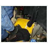 Contents of closet under the stairs. Visible items include a Panasonic tube television, canning jars, winter coats and more