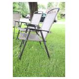 A Set Of Four Tan Lawn Chairs