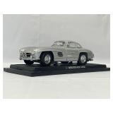 Four Model Cars and Wooden Train. Mercedes-Benz 300SL, Volvo PV 544, 1934 Duesenberg, 1937 Cord 812.