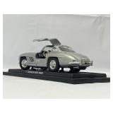Four Model Cars and Wooden Train. Mercedes-Benz 300SL, Volvo PV 544, 1934 Duesenberg, 1937 Cord 812.