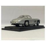 Four Model Cars and Wooden Train. Mercedes-Benz 300SL, Volvo PV 544, 1934 Duesenberg, 1937 Cord 812.