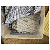 Bin of New and Used Pajama Tops and Bottoms.