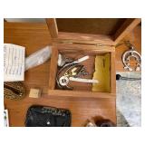 Books on Travel to Europe and Variety of Trinkets, Leather Wallets, and Necklaces for Men.