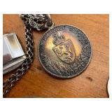 Books on Travel to Europe and Variety of Trinkets, Leather Wallets, and Necklaces for Men.