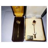 Two vintage label pins with genuine garnets