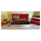 Yellow Volkswagen 1300 cabriolet model car in case, double nine dragon dominoes vintage game, and welcome to Britain double-decker bus model car