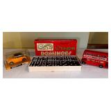 Yellow Volkswagen 1300 cabriolet model car in case, double nine dragon dominoes vintage game, and welcome to Britain double-decker bus model car