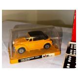 Yellow Volkswagen 1300 cabriolet model car in case, double nine dragon dominoes vintage game, and welcome to Britain double-decker bus model car