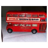 Yellow Volkswagen 1300 cabriolet model car in case, double nine dragon dominoes vintage game, and welcome to Britain double-decker bus model car