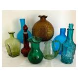 Variety of Colorful Glass Bottles and Vases