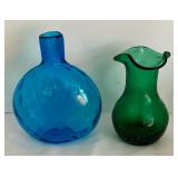 Variety of Colorful Glass Bottles and Vases