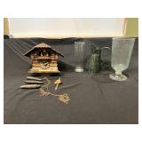 Vintage Cuckoo Clock with Pendulum, Glassware, and Decorative Metal Pitcher