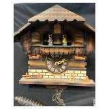 Vintage Cuckoo Clock with Pendulum, Glassware, and Decorative Metal Pitcher