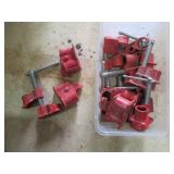 Lot of Red Scaffold Clamps, Hooks, and Caster Wheels