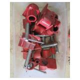 Lot of Red Scaffold Clamps, Hooks, and Caster Wheels