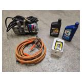 Portable PowerPal air compressor, jumper cables, 2 quarts of motor oil (Mag 1 is open and about 75% full) and one John Deer T19044 oil filter for tractors
