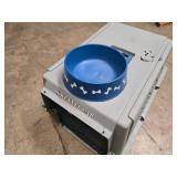 small portable kennel and dog bowl