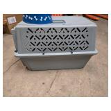 small portable kennel and dog bowl