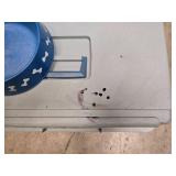 small portable kennel and dog bowl