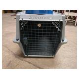 small portable kennel and dog bowl