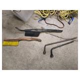 a bucket of bungee straps / tie downs/ and ropes, 2 windshield brushes and 2 tire irons